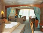 ID 2828 AURORA (2000/76152grt/IMO 9169524) - A Mini suite comprising lounge area with sofa, armchairs, dining table and chairs. Full length windows to private balcony and separate bedroom area with two beds...