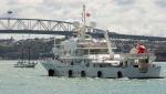 ID 10615 SENSES (993grt) arriving Auckland from Fiji complete with helicopter on the after deck helipad. Passengers aboard the replica flat-bottomed scow TED ASHBY, based at the Voyager Maritime Museum here in...
