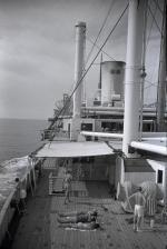 ID 8198 Lazy days in the Pacific approaching Panama on the RANGITANE, homeward bound from Wellington, New Zealand.  A view from the docking bridge aft, where some of the crew would enjoy the sun.  The...