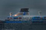 ID 10785 OVATION OF THE SEAS (2016/168666grt/IMO 9697753/348m loa) - the largest ship to ever visit New Zealand, slides into Auckland at the crack of another grey summer dawn. Too large to berth at any wharf...